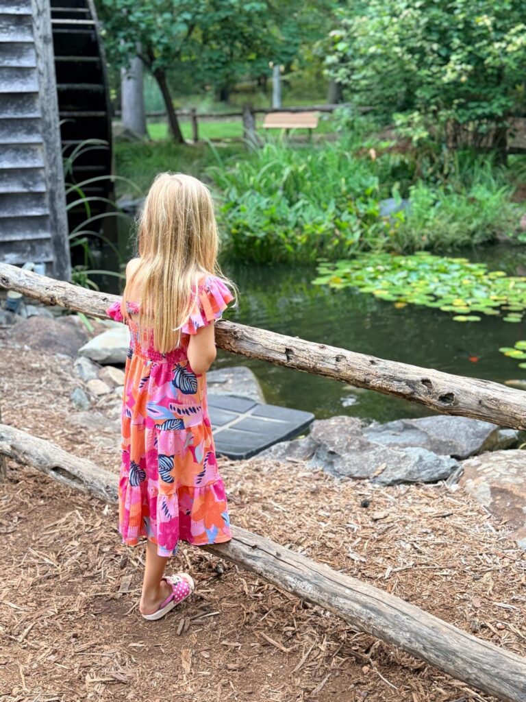 Tanger Family Bicentennial Gardens girl looking at the pond
