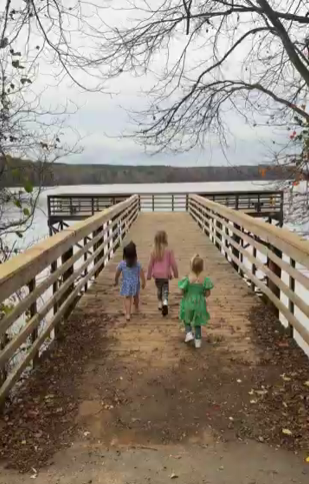 lake brandt bur-mil park in the fall by the lake three kids walking